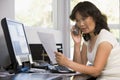 Woman in home office with paperwork on telephone Royalty Free Stock Photo