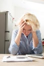 Woman at Home Stares at Accounts with Head in Hands Royalty Free Stock Photo