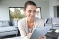 Woman at home websurfing on tablet Royalty Free Stock Photo
