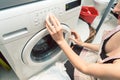 Woman homemaker operating the washing machine