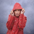 Woman, hood and portrait with rain, coat and clouds with protection in nature. Person, face and storm with cloudy