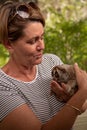 Woman in hooped shirt holding slow loris Royalty Free Stock Photo