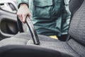 Woman hoovering a car cabin. Vacuum cleaning car seats interior.