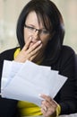 Woman horrified by bills Royalty Free Stock Photo