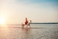 Woman and horse on the background of sky and water. Girl model o Royalty Free Stock Photo