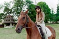 Woman with horse in countryside. A charming female rider on her horse. Equestrianism fosters well-being, relaxation. Young lady