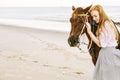 Woman and horse near sea