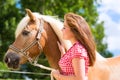 Woman with horse on pony farm Royalty Free Stock Photo