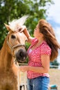 Woman with horse on pony farm Royalty Free Stock Photo