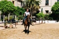 Woman horse rider riding a brown andalusian horse in Historic Ro