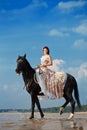 Woman on a horse by the sea