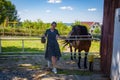 Woman with horse in stable at countryside ranch. Girl horse rider in summer outdoor. Equestrian and horseback riding. Horse Royalty Free Stock Photo