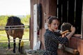 Woman with horse in stable at countryside ranch. Girl horse rider in summer outdoor. Equestrian and horseback riding. Horse Royalty Free Stock Photo