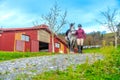 Woman and horse walking outside an equestrian center Royalty Free Stock Photo