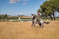 Woman horsewoman, young and beautiful, performing cowgirl dressage exercises with her horse, in the countryside. Concept horse Royalty Free Stock Photo