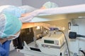 Woman on hospital stretcher above diagnostic machines