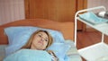 A woman in a hospital undergoing UV blood irradiation therapy