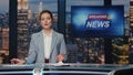 Woman host presenting newscast standing tv stage near screen. Lady breaking news Royalty Free Stock Photo