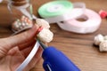 Woman with hot glue gun making craft at wooden table, closeup Royalty Free Stock Photo