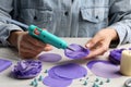 Woman with hot glue gun making craft at wooden table, closeup Royalty Free Stock Photo