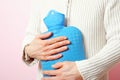 Woman with hot water bottle Royalty Free Stock Photo