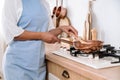 woman housewife cooking lunch in frying pan on gas stove Royalty Free Stock Photo