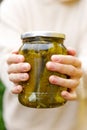 Woman housewife hand holding glass jar of pickled cucumbers. Domestic preparation pickling and canning of vegetables Royalty Free Stock Photo