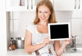 Woman housewife in the kitchen with an blank empty tablet computer Royalty Free Stock Photo
