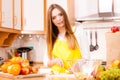 Woman housewife in kitchen cutting apple fruits Royalty Free Stock Photo