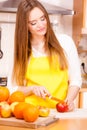 Woman housewife in kitchen cutting apple fruits Royalty Free Stock Photo