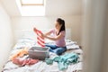 Woman or housewife sorting laundry at home