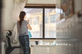 A woman housewife spraying window cleaner at the glass