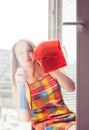 Woman housewife washes a window