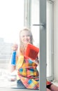 Woman housewife washes a window