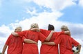 Woman, hug and back of soccer team ready for sports match, game or outdoor practice with blue sky. Rear view of female Royalty Free Stock Photo