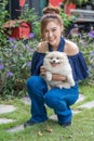 Woman hug with pomeranian dog in garden Royalty Free Stock Photo