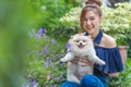 Woman hug with pomeranian dog in garden Royalty Free Stock Photo