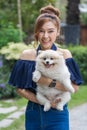 Woman hug with pomeranian dog in garden Royalty Free Stock Photo