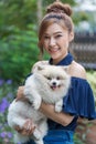 Woman hug with pomeranian dog in garden Royalty Free Stock Photo