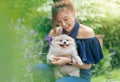 Woman hug with pomeranian dog in garden Royalty Free Stock Photo