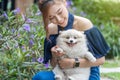 Woman hug with pomeranian dog in garden Royalty Free Stock Photo