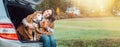 Woman huges her dog with shawls sitting together in car trunk Royalty Free Stock Photo