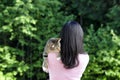 Woman hugging family pet cat while outdoors during nice day Royalty Free Stock Photo