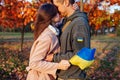 Woman hugging husband in ukrainian military uniform with flag and chevron. Sad stressed couple outdoors. Back from war Royalty Free Stock Photo