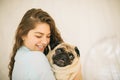 Woman hugging pet pug. Lovely family portrait