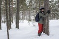 A woman is hugging a tree in a winter forest. The concept of con Royalty Free Stock Photo