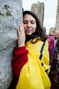 Woman hugs a stone at Stonehenge wiltshire England