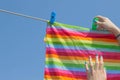 A woman hung washed laundry outdoors. Girl drying laundry on a clothes line in the sun in the outdoor