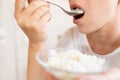 the woman is hungry and therefore eats rice with spoons Royalty Free Stock Photo