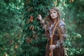 Woman hunter with a bow in hand in the forest. Amazon